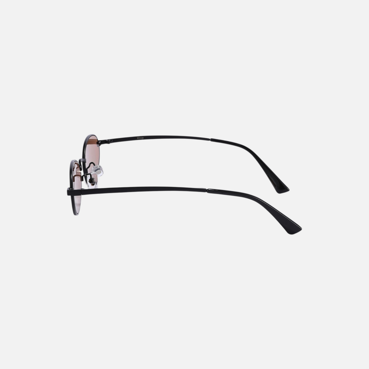Miraje oval frame sunglasses featuring a slim black metal frame and warm amber-tinted lenses, side profile view.