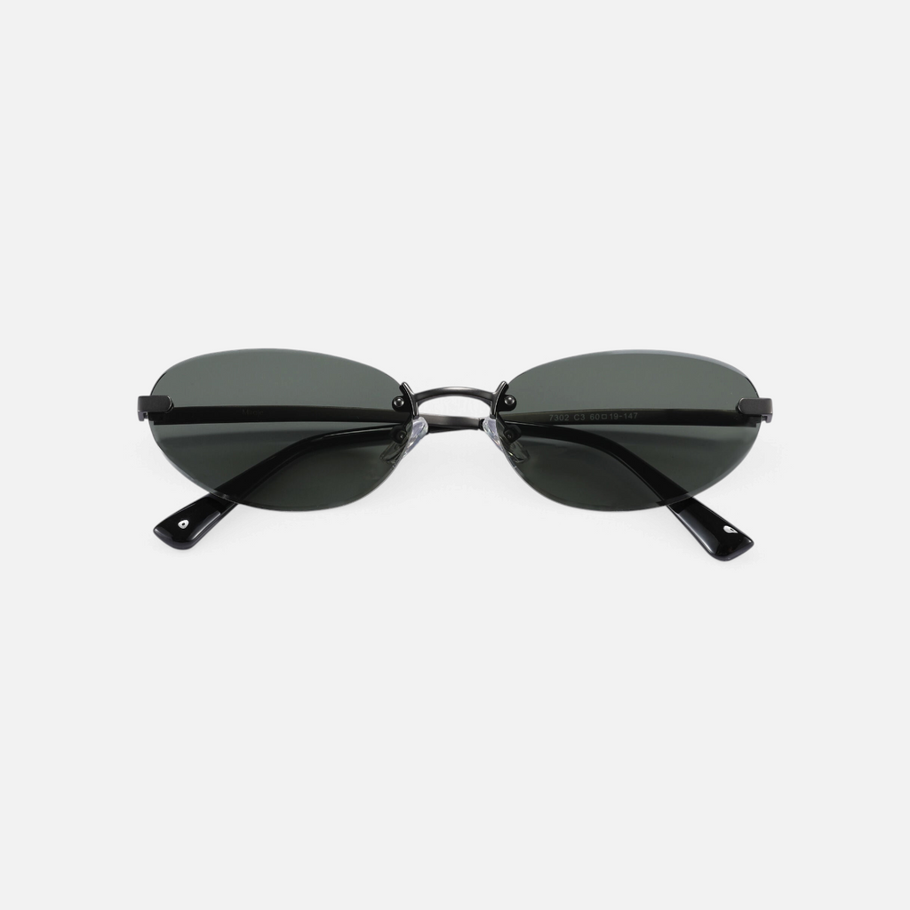 Miraje rimless oval sunglasses featuring a gunmetal metal frame and dark tinted lenses for a minimalist aesthetic.