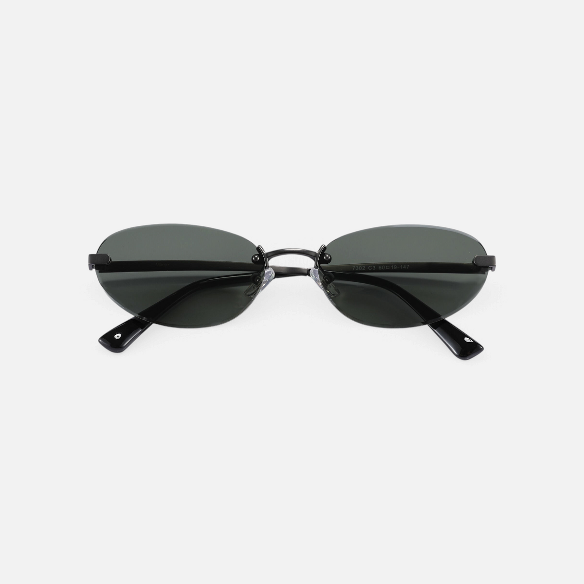 Miraje rimless oval sunglasses featuring a gunmetal metal frame and dark tinted lenses for a minimalist aesthetic.